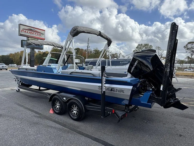 Slide: The Image of 2025 SeaArk Super Lounge Easy boat on trailer under cloudy sky. - 4