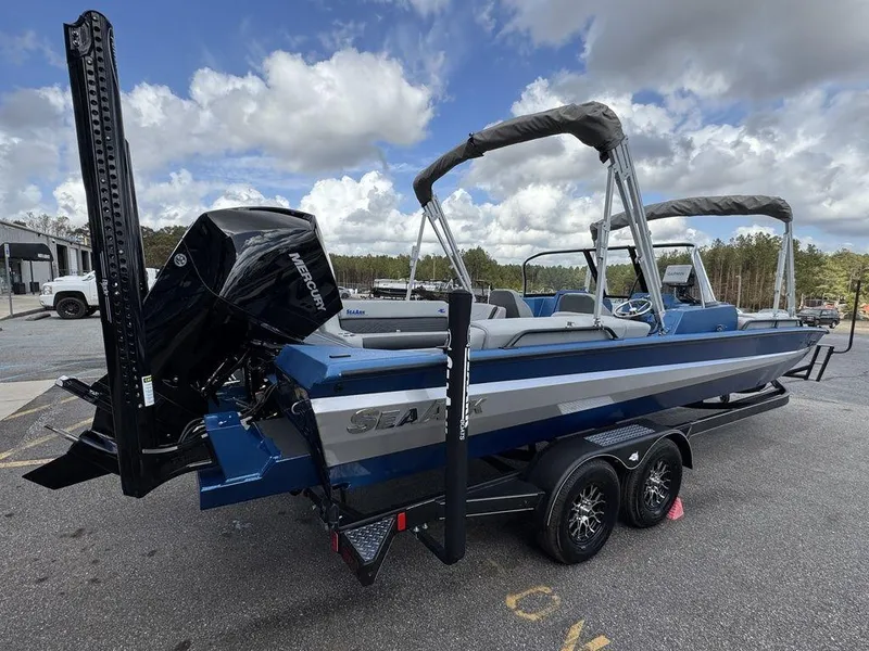 Slide: The Image of 2025 SeaArk Super Lounge Easy boat on trailer, blue and gray design, outdoor setting. - 6