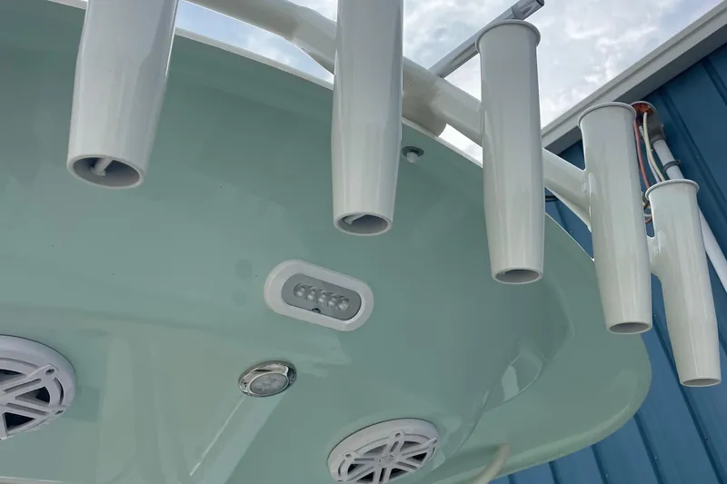 Slide: The Image of 2025 Cobia 220 Center Console boat with rod holders and speakers. - 7