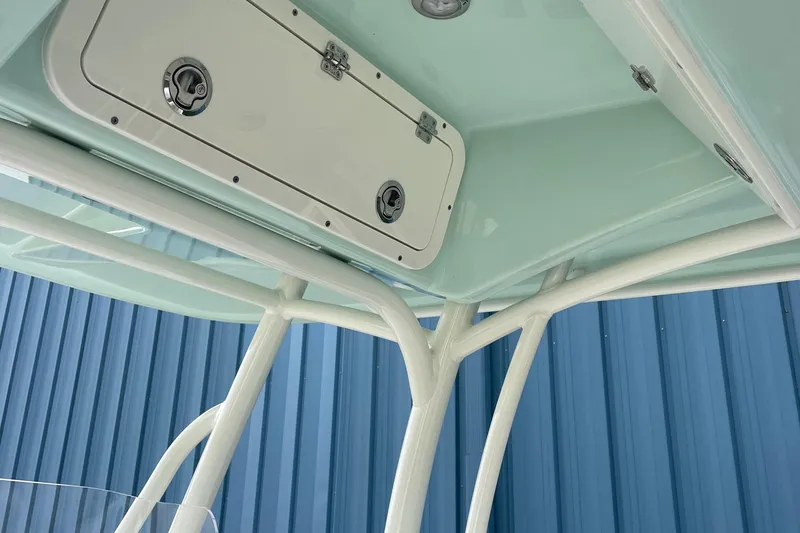 Slide: The Image of 2025 Cobia 220 Center Console boat, featuring a sleek overhead storage compartment. - 8