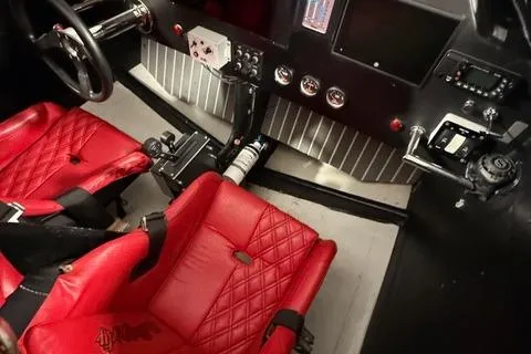 Slide: The Image of Interior of a 2019 Phantom SV 32 race car with red bucket seats. - 6