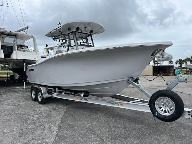 The Image of 2025 Sea Pro 262 Sport boat on trailer, parked outdoors. - 1