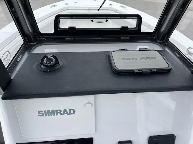 Slide: The Image of 2025 Sea Pro 262 Sport dashboard with Simrad navigation system and compass. - 14