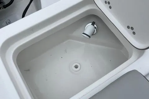 Slide: The Image of 2025 Sea Pro 262 Sport boat livewell interior with drain and nozzle. - 16