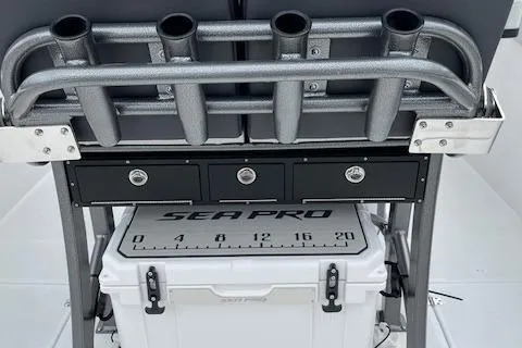 Slide: The Image of 2025 Sea Pro 262 Sport boat with rod holders and storage compartments. - 6