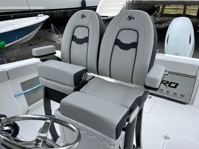 Slide: The Image of 2025 Sea Pro 262 Sport boat seats with armrests and steering wheel. - 9