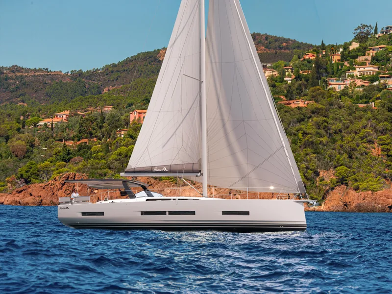 Slide: The Image of 2025 Hanse 590 yacht sailing near scenic coastline with lush greenery. - 45