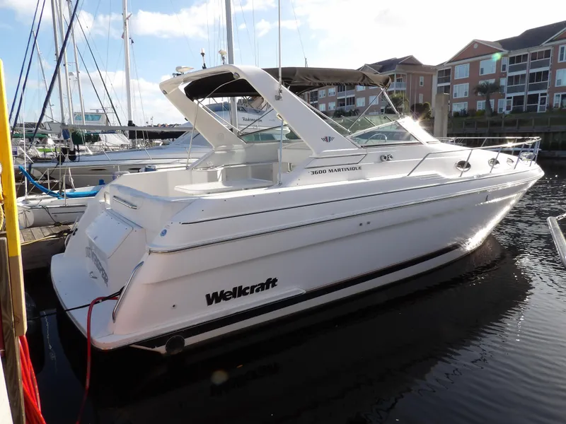 Slide: The Image of 1998 Wellcraft Martinique 3600 boat docked at marina, white exterior, sunny day. - 0