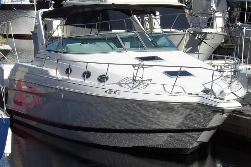 Slide: The Image of 1998 Wellcraft Martinique 3600 yacht docked at marina, sleek white design. - 1