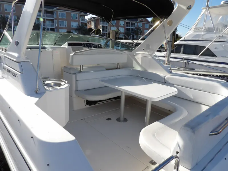 Slide: The Image of 1998 Wellcraft Martinique 3600 boat interior with white seating and table. - 10