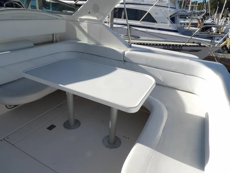 Slide: The Image of 1998 Wellcraft Martinique 3600 boat interior with white seating and table. - 11