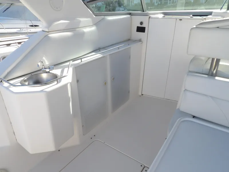 Slide: The Image of 1998 Wellcraft Martinique 3600 boat interior with sink and seating area. - 15