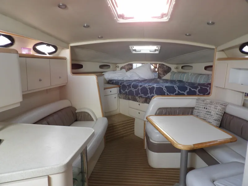 Slide: The Image of Interior of 1998 Wellcraft Martinique 3600 yacht with cozy seating and sleeping area. - 18