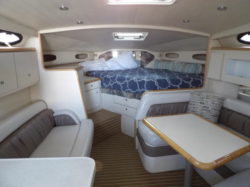 Slide: The Image of 1998 Wellcraft Martinique 3600 cabin interior with bed, seating, and table. - 19
