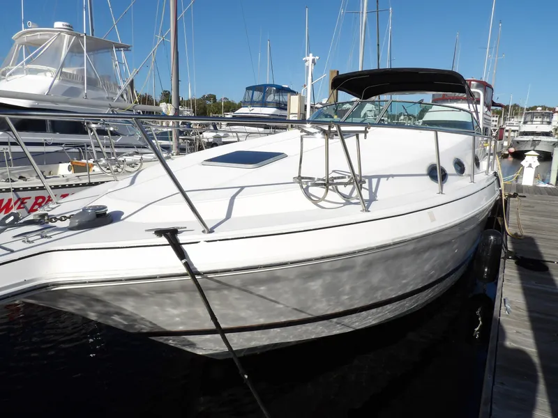 Slide: The Image of 1998 Wellcraft Martinique 3600 yacht docked at marina, side view. - 2