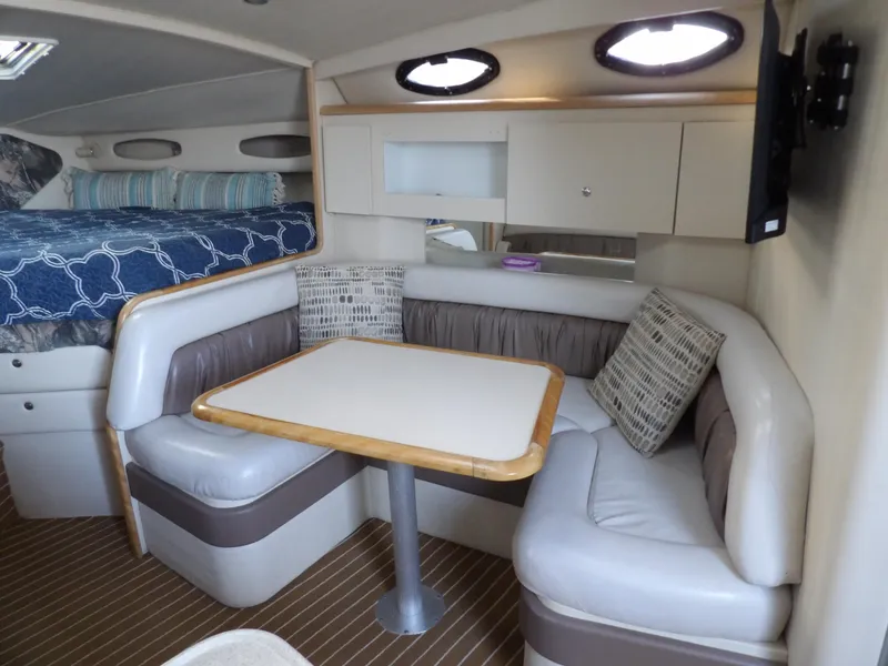 Slide: The Image of 1998 Wellcraft Martinique 3600 interior with cozy dining area and bed. - 21