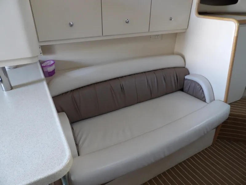Slide: The Image of Interior of 1998 Wellcraft Martinique 3600 with beige sofa and cabinetry. - 23