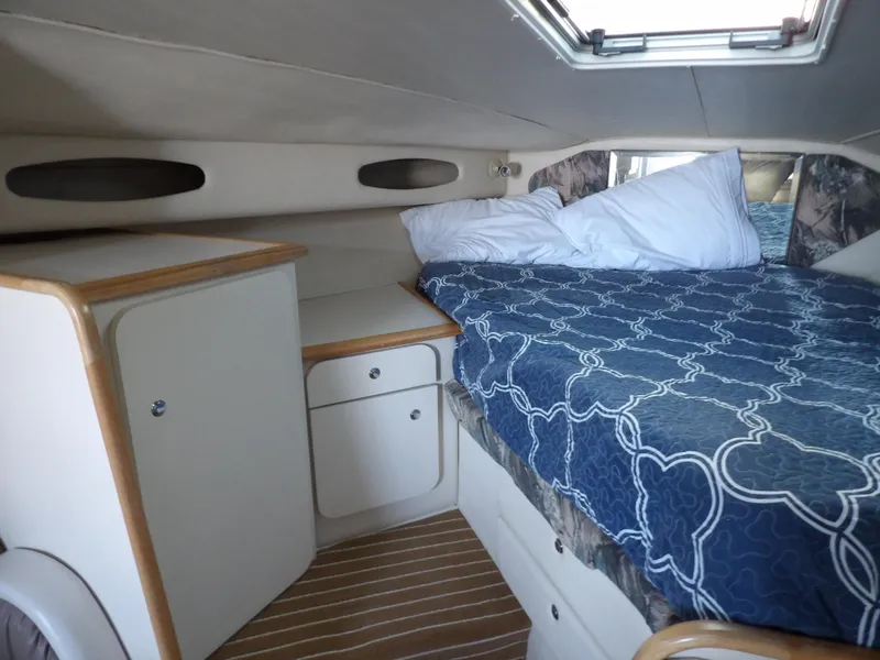 Slide: The Image of Cozy cabin interior of 1998 Wellcraft Martinique 3600 with bed and storage cabinets. - 24