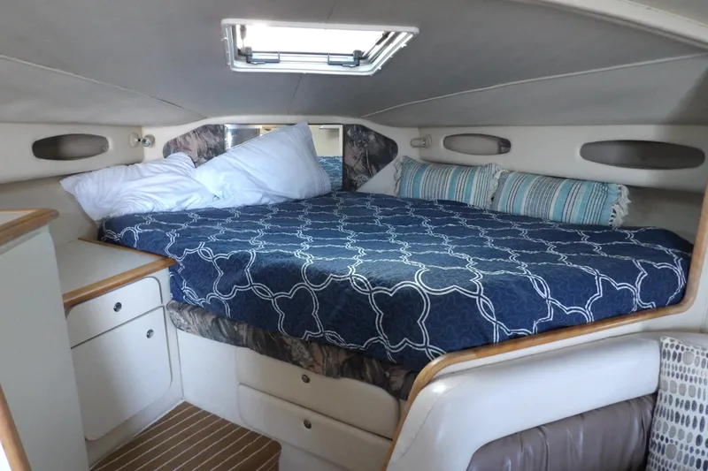 Slide: The Image of Cozy cabin interior of 1998 Wellcraft Martinique 3600 with comfortable bedding and storage. - 25