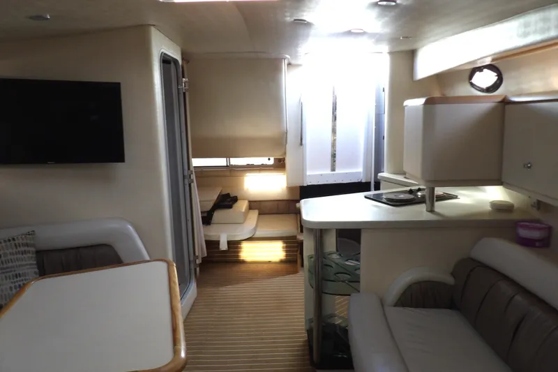 Slide: The Image of Interior of 1998 Wellcraft Martinique 3600 yacht, featuring modern seating and kitchen area. - 29