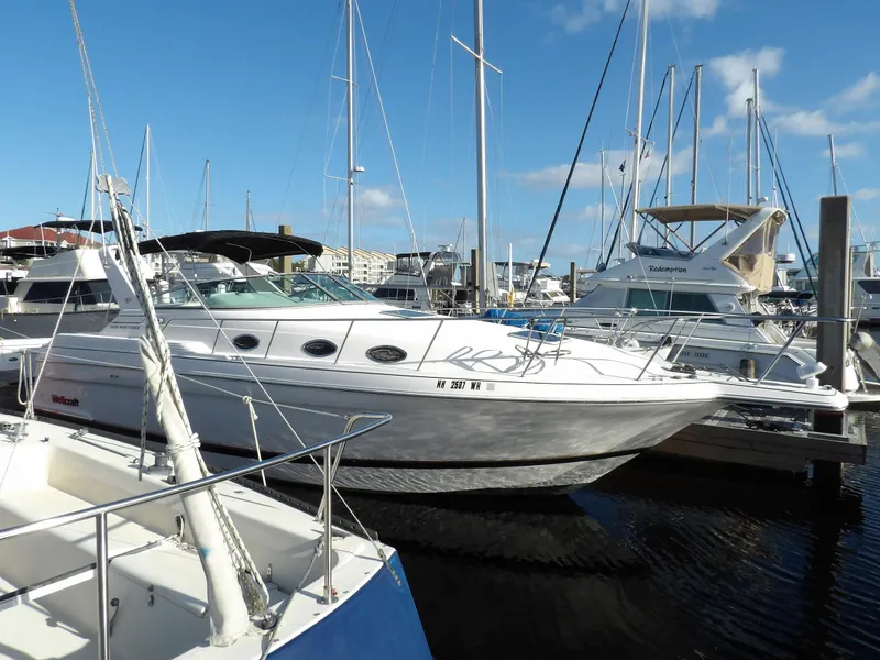 Slide: The Image of 1998 Wellcraft Martinique 3600 yacht docked in a marina, surrounded by other boats. - 3