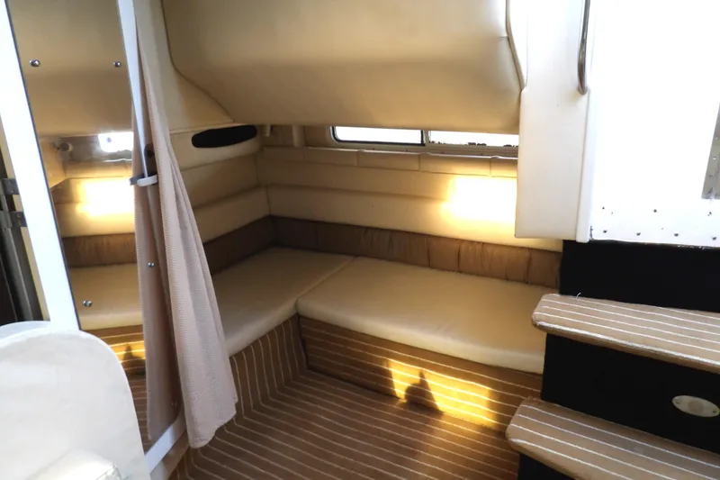 Slide: The Image of Interior of 1998 Wellcraft Martinique 3600 boat, featuring cozy seating and ambient lighting. - 32
