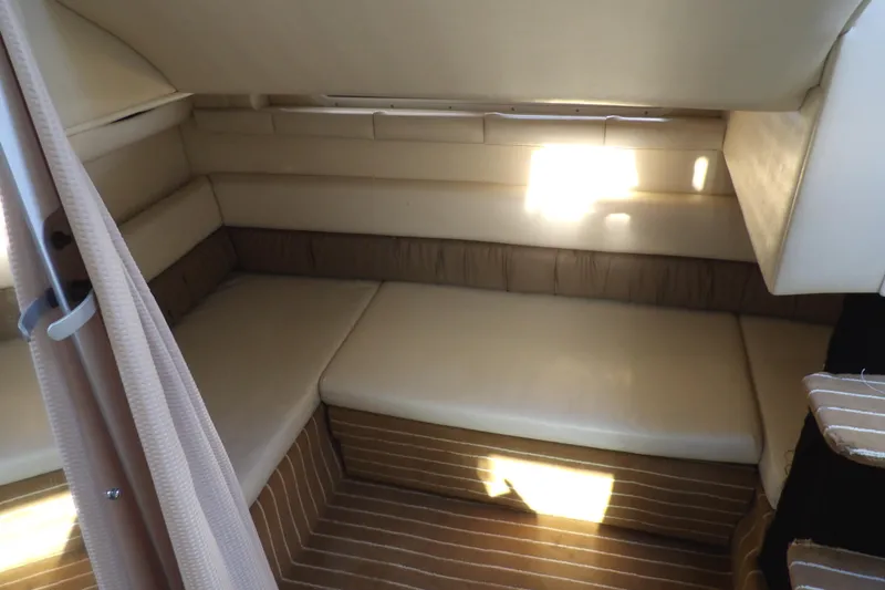 Slide: The Image of 1998 Wellcraft Martinique 3600 cabin interior with beige seating and striped flooring. - 33