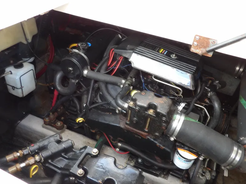 Slide: The Image of Engine compartment of a 1998 Wellcraft Martinique 3600 boat, showcasing mechanical components. - 38