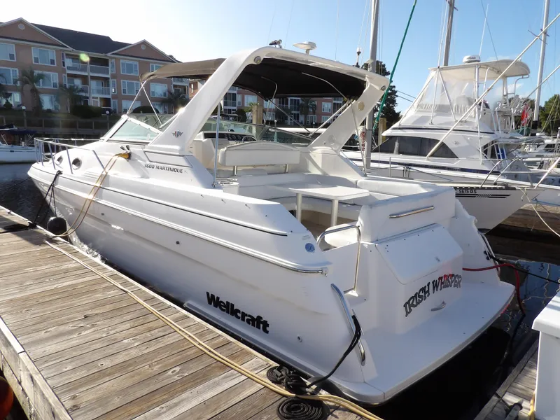 Slide: The Image of 1998 Wellcraft Martinique 3600 boat docked at marina, rear view. - 4