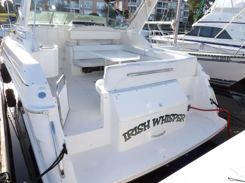 Slide: The Image of 1998 Wellcraft Martinique 3600 yacht docked, featuring spacious seating and "Irish Whisper" name. - 7