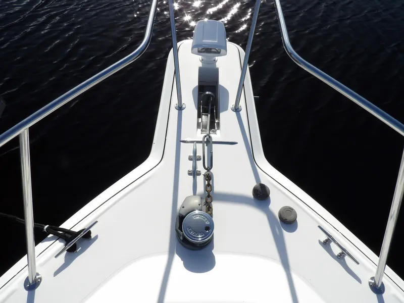 Slide: The Image of Bow view of 1998 Wellcraft Martinique 3600 boat with anchor and railing. - 8