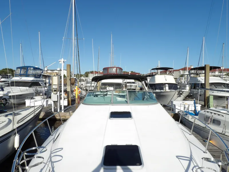 Slide: The Image of 1998 Wellcraft Martinique 3600 yacht docked in a marina, surrounded by other boats. - 9