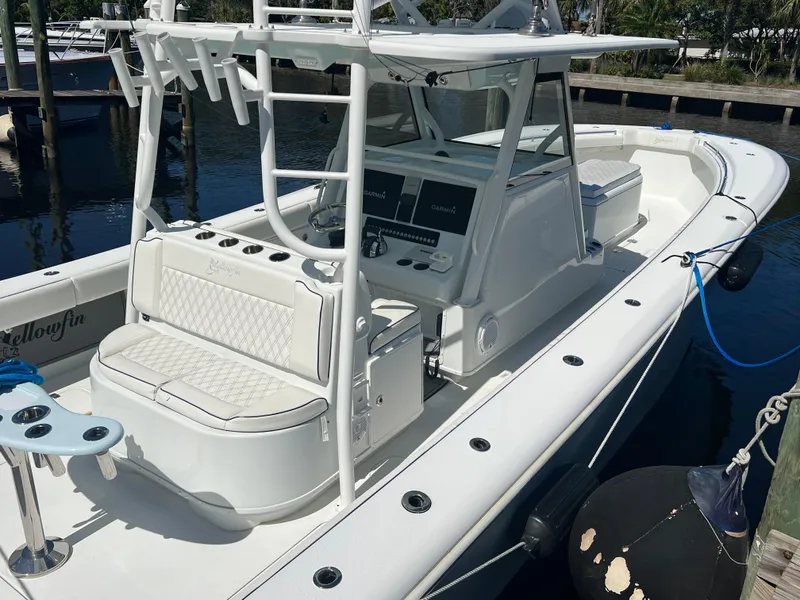 Slide: The Image of 2017 Yellowfin 39 Offshore boat docked, featuring spacious seating and modern controls. - 11
