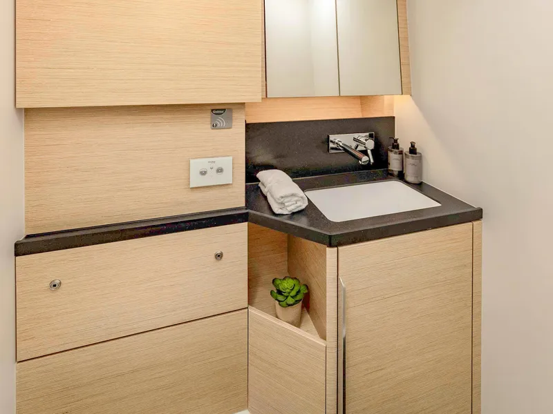 Slide: The Image of Modern bathroom sink area in 2025 Hanse 510 yacht, featuring sleek cabinetry and fixtures. - 13