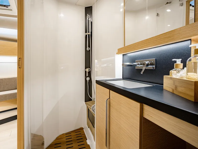 Slide: The Image of Luxurious bathroom in 2025 Hanse 510 yacht with modern fixtures and wooden accents. - 16