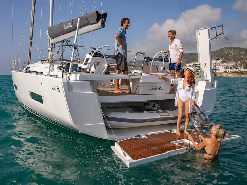 Slide: The Image of 2025 Hanse 510 yacht with people enjoying the deck and swim platform. - 20