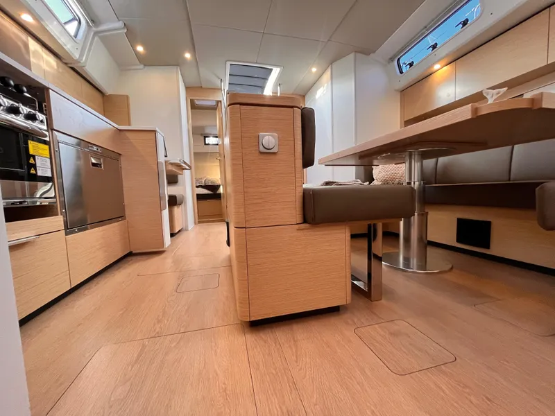 Slide: The Image of Modern interior of 2025 Hanse 460 yacht with sleek kitchen and dining area. - 13