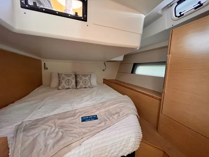 Slide: The Image of Cozy cabin interior of 2025 Hanse 460 yacht with bed and wooden furnishings. - 18