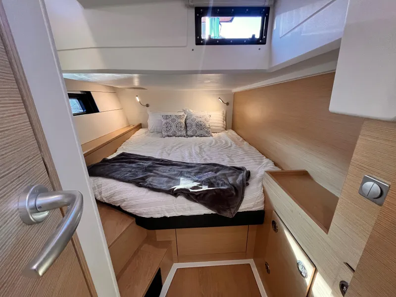 Slide: The Image of Cozy cabin interior of 2025 Hanse 460 yacht with bed and wooden accents. - 20