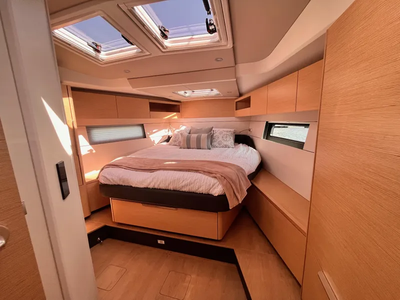 Slide: The Image of Luxurious 2025 Hanse 460 yacht cabin with skylights and modern wood finish. - 23