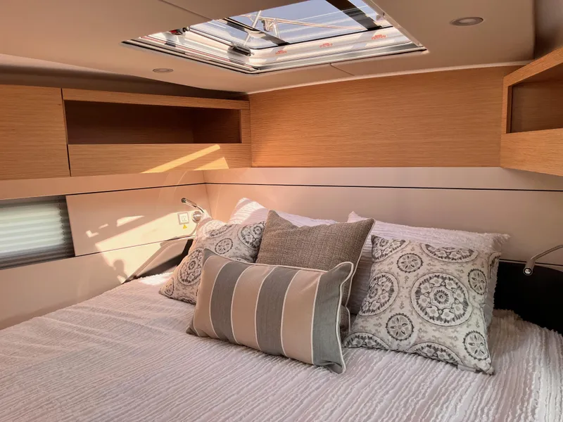 Slide: The Image of Luxurious cabin interior of 2025 Hanse 460 yacht with skylight and cozy bedding. - 26