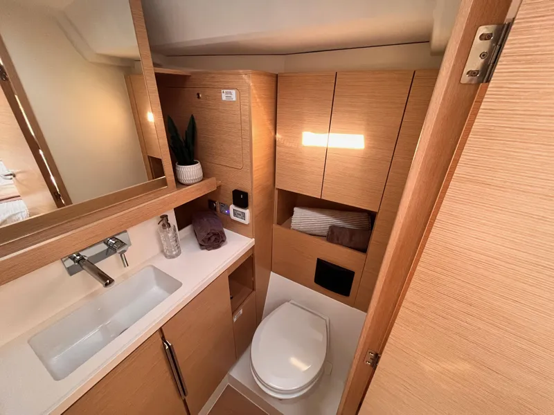 Slide: The Image of Modern bathroom in 2025 Hanse 460 yacht with sleek wood cabinetry and white fixtures. - 27