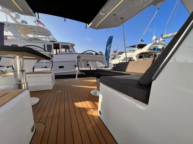 Slide: The Image of Luxurious 2025 Hanse 460 yacht interior with sleek wooden deck and modern seating. - 4