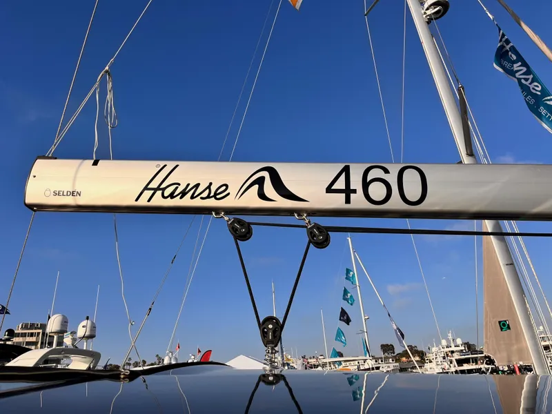 Slide: The Image of 2025 Hanse 460 sailboat mast with marina background and clear blue sky. - 42