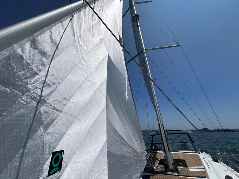 Slide: The Image of Sailing on a 2025 Hanse 460 yacht with white sails against a clear blue sky. - 44