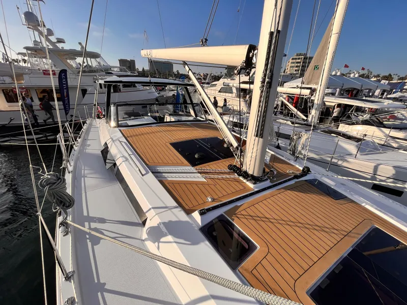 Slide: The Image of 2025 Hanse 460 yacht with sleek deck design at marina. - 6