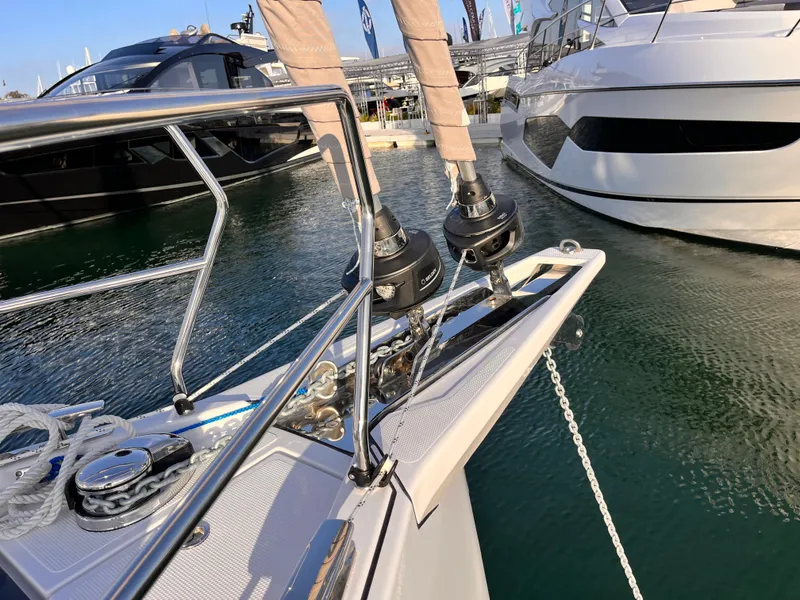 Slide: The Image of Hanse 460 yacht bow, 2025 model, docked at marina with other boats. - 7