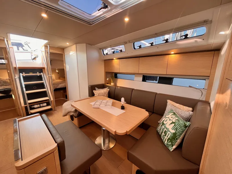 Slide: The Image of Luxurious interior of 2025 Hanse 460 yacht with modern seating and dining area. - 9
