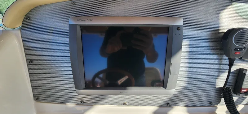 Slide: The Image of Dashboard of 2013 Chris-Craft Catalina 29 Sun Tender with navigation screen and radio. - 10