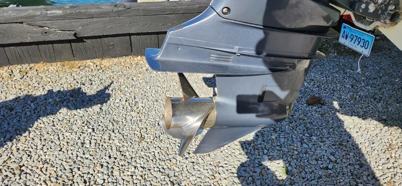 Slide: The Image of Close-up of a 2013 Chris-Craft Catalina 29 Sun Tender boat propeller on gravel. - 15